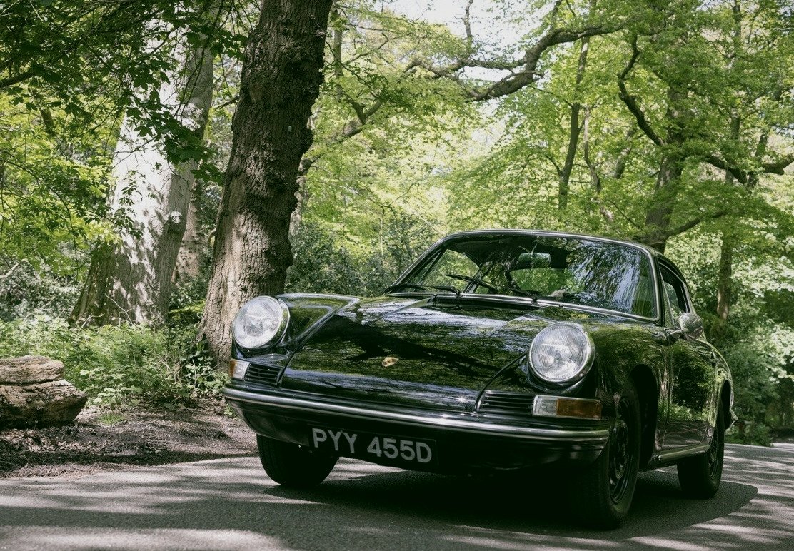 Classic black Porsche 912 photographed on a woodland track