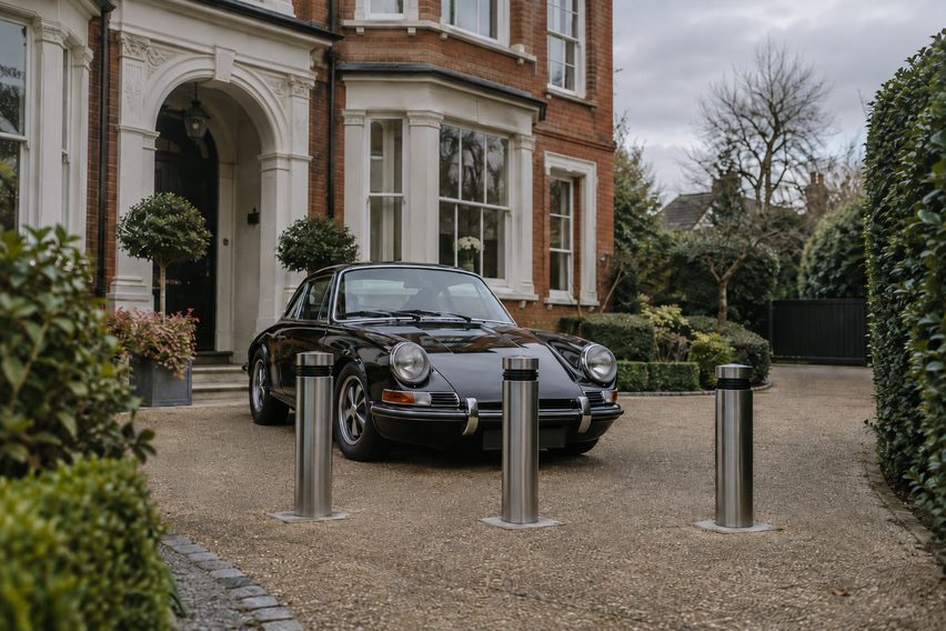 Classic Porsche 911 on a private London driveway behind security bollards