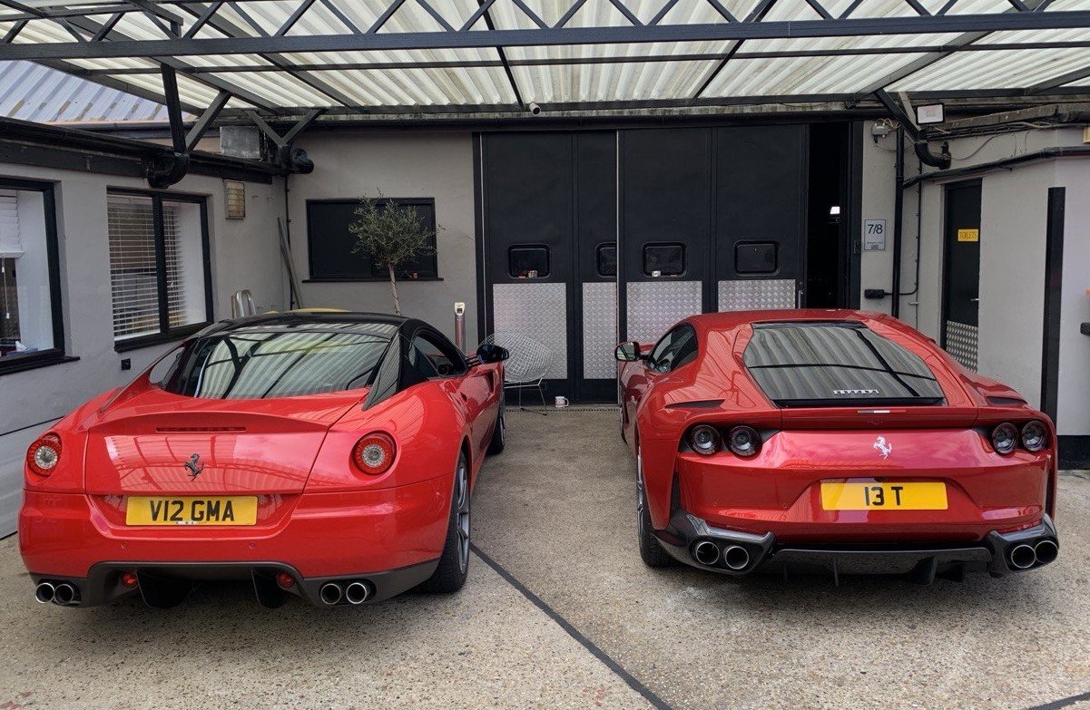 Two red Ferraris parked rear on inside the private Equerry 55 storage building